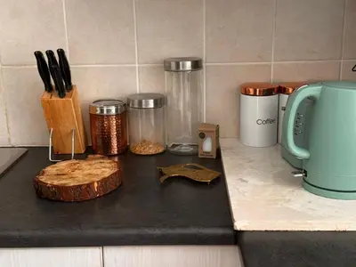 a kitchen counter with a cutting board and utensils at Divine Favor House on 44 Torrington in Cape Town