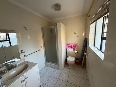 a bathroom with a shower and a toilet and a sink at Family Home with Big Garden & Jacuzzi in Welgelegen