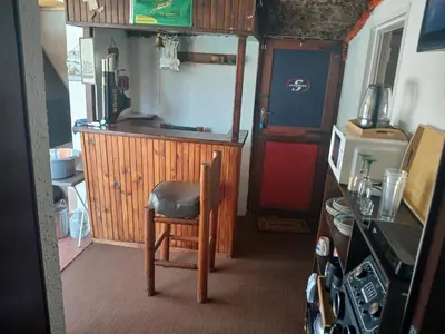a small kitchen with a chair in a room at Braai and chill getaway in Goodwood
