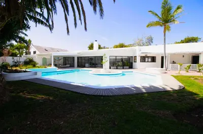 a swimming pool in the backyard of a house at Northcliff House in Hermanus