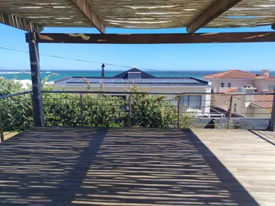 a view of the ocean from the deck of a house at Paradise Piet Haven in Hermanus