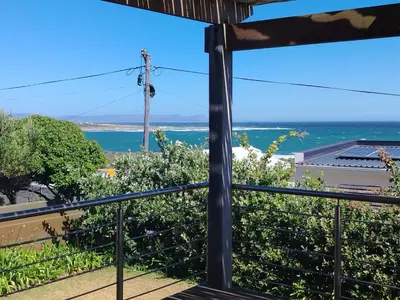 a view of the ocean from the balcony of a house at Paradise Piet Haven in Hermanus