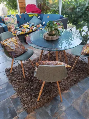 a glass table with chairs and a couch at Carol's Place in Somerset West