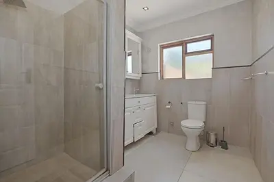 a bathroom with a toilet and a sink and a shower at Briza Breeze in Cape Town