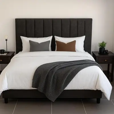 a large bed with a black headboard and pillows at Majestic Mountain views in the Cape Town Winelands in Stellenbosch