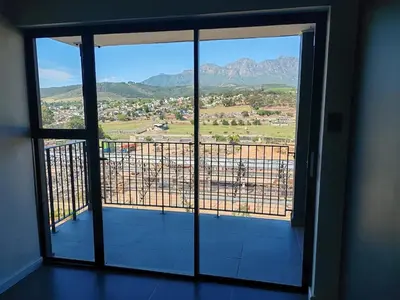 a room with a window with a view of the mountains at Majestic Mountain views in the Cape Town Winelands in Stellenbosch