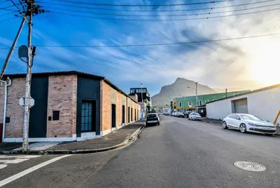 a street with cars parked on the side of the road at Modern Boho Loft- Observatory in Cape Town