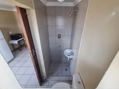 a bathroom with a shower with a toilet and a sink at Bird Retreat in Zeekoevlei