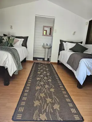 a bedroom with two beds and a sink at The Lineage Lodge in Elgin