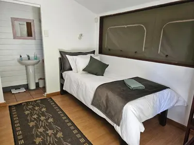 a bedroom with a large bed and a sink at The Lineage Lodge in Elgin