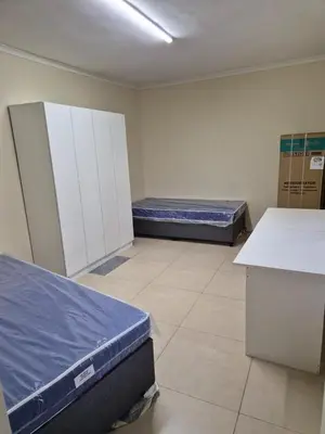 a room with two beds in a hospital room at The Lavender Residence in Belhar