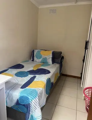 a bedroom with a bed in a room at The Lavender Residence in Belhar