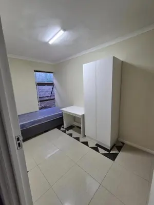 an empty room with a bench and a window at The Lavender Residence in Belhar