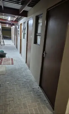 a row of doors in a hallway of a building at The Lavender Residence in Belhar