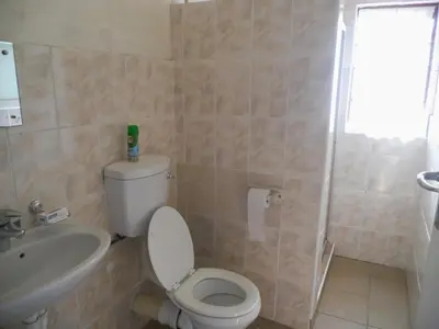 a bathroom with a toilet and a sink and a shower at Twin Oaks Lodges in Cape Town