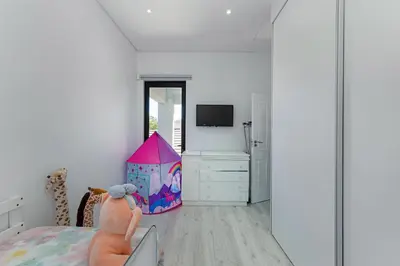 a bedroom with a bed and a play house at Sunset Sundowners Villa in Cape Town