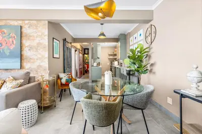 a living room with a table and chairs at Waves and Wildflowers in Cape Town
