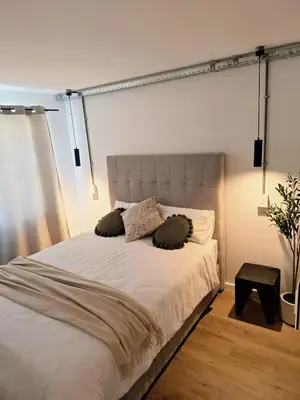 a bed with two pillows on it in a bedroom at Green Olive Luxury Stay - Cozy, modern and central in Tygerberg Hills