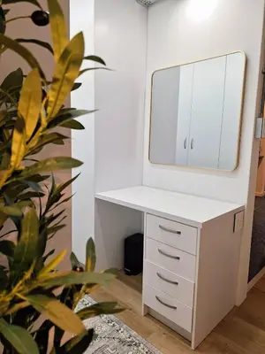 a dressing table and mirror in a room with a plant at Green Olive Luxury Stay - Cozy, modern and central in Tygerberg Hills