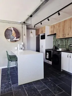 a kitchen with a white counter and a stove at Green Olive Luxury Stay - Cozy, modern and central in Tygerberg Hills