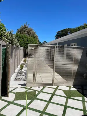 a fence in a yard with a concrete patio at Blouberg kiters in Cape Town