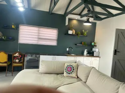 a living room with a couch in a kitchen at Blouberg kiters in Cape Town