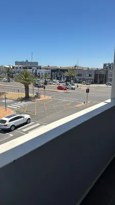 a car parked in a parking lot next to a street at Cape on Popham apartment in Cape Town