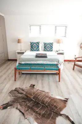 a bedroom with a bed with a large fish on the floor at Abalone at Hermanus Reefs in Hermanus
