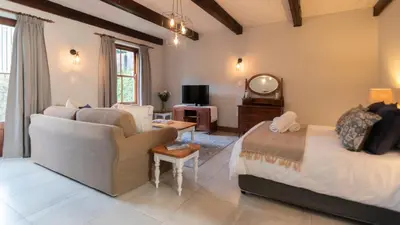 a living room with a bed and a couch at Mountain and Tides in Kleinmond