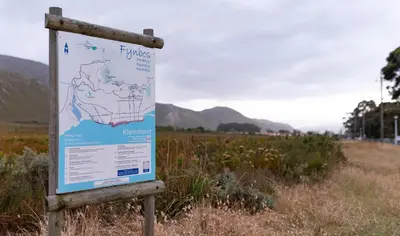 a sign in the middle of a field at Mountain and Tides in Kleinmond