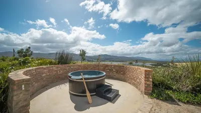 a hot tub in a brick wall at Swallows Rest - Benguela Cove in Hermanus