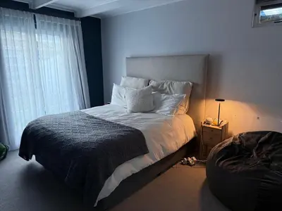 a bedroom with a large bed and a window at Modern & Secure 3-Bed Home with Pool & Garden in Cape Town