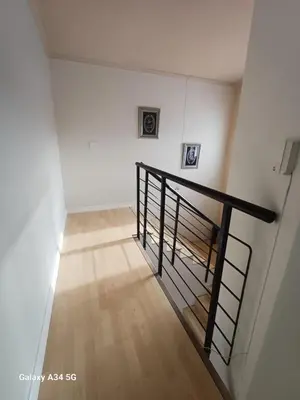 a staircase in a room with white walls and wooden floors at On The Bay in Strandfontein