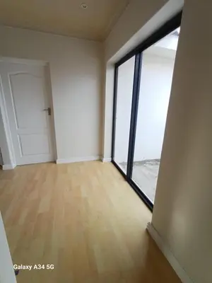 an empty room with a large window and a door at On The Bay in Strandfontein