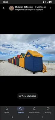 a picture of a row of beach huts on the beach at On The Bay in Strandfontein