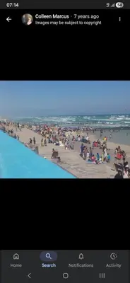 a television screen with a picture of a beach at On The Bay in Strandfontein