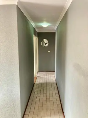 a hallway with green walls and a tile floor at Unit 1, TraversHub Sleeps 6 Self-Catering Group Belhar, CT in Belhar