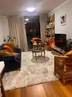 a living room with a blue couch and a table at Divine Apartment Century City in Cape Town