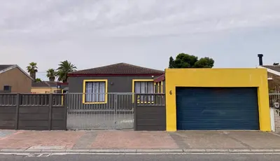 a house with a garage door and a fence at Unit 2 TraversHub Sleeps 6 Self-Catering Group Belhar, CT in Belhar