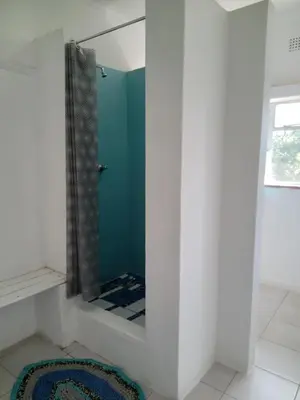 a bathroom with a mirror and a blue shower at A Rustic and Reflective Nature Getaway in Greyton in Greyton