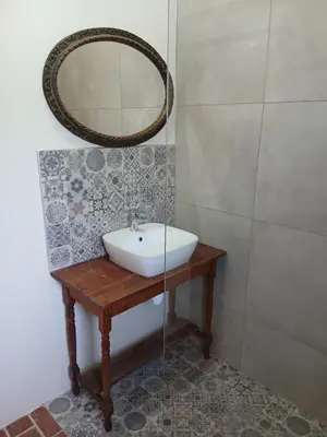 a bathroom with a sink and a mirror at Chasselas Studio in Somerset West