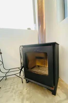 a microwave oven sitting in the corner of a room at Fynbossie in Pringle Bay