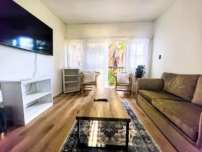 a living room with a couch and a coffee table at Offbeat off Dorp in Stellenbosch