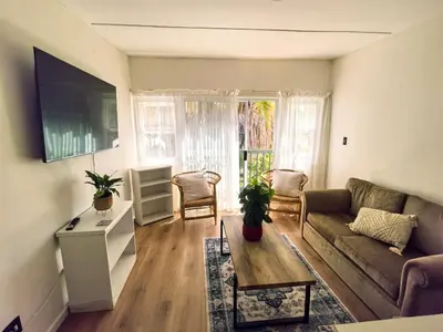 a living room with a couch and a table at Offbeat off Dorp in Stellenbosch