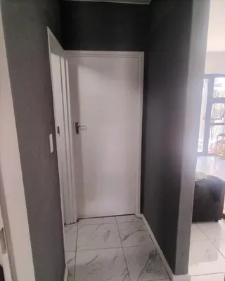 a hallway with a white door in a room at Beach Vibes Villa in Cape Town
