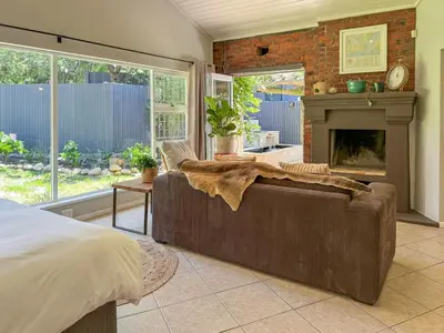 a living room with a couch and a fireplace at Spacious Holiday house with swimming pool in Blomtuin