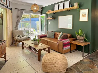 a living room with a couch and a table at Spacious Holiday house with swimming pool in Blomtuin