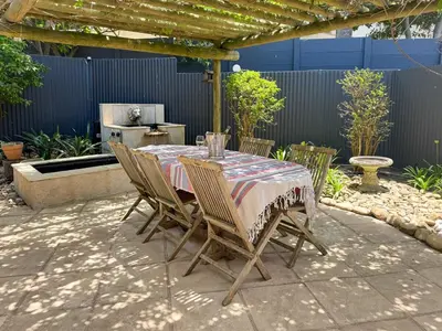a table and chairs sitting on a patio at Spacious Holiday house with swimming pool in Blomtuin