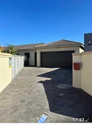 a house with a parking lot with a garage at Holiday Home in Cape Town