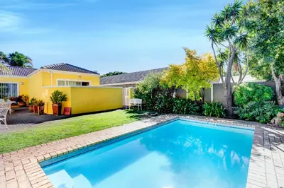 a swimming pool in the backyard of a house at Sea Breeze Kite Dreams 3 in Cape Town